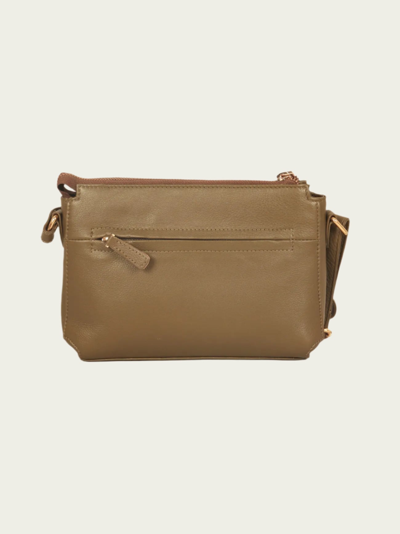 Green leather handbag on a beige background