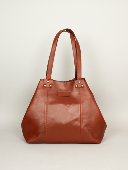 Close-up of premium leather texture and gold-tone hardware on women's office tote bag